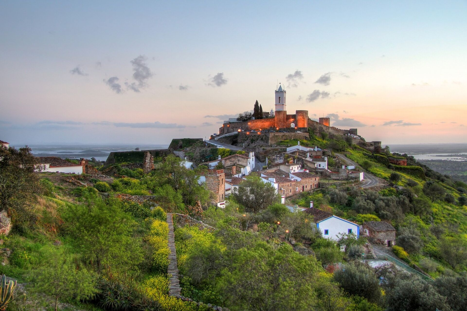 The medieval hilltop village of Monsaraz, Alentejo, overlooking the Alqueva plains at sunset